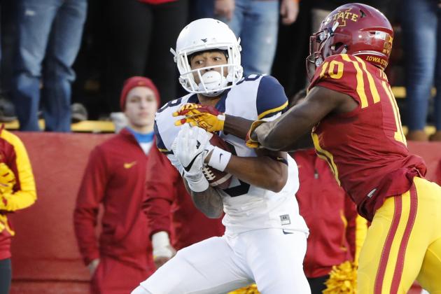 AMES, IA Ð NOVEMBER 26: Wide receiver Marcus Simms #8 of the West Virginia Mountaineers pulls in a touchdown pass over defensive back Brian Peavy #10 of the Iowa State Cyclones in the first half of play at Jack Trice Stadium on November 26, 2016 in Ames, Iowa. (Photo by David Purdy/Getty Images)