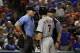 Home plate umpire Angel Hernandez, listens to Detroit Tigers' Ian Kinsler (3) as manager Brad Ausmus stands by in the fifth inning of a baseball game, Monday, Aug. 14, 2017, in Arlington, Texas. Kinsler and Ausmus were ejected by Hernandez during the argument. (AP Photo/Tony Gutierrez)