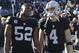 Oakland Raiders defensive end Khalil Mack (52) and quarterback Derek Carr (4) before an NFL football game against the Indianapolis Colts in Oakland, Calif., Saturday, Dec. 24, 2016. (AP Photo/Marcio Jose Sanchez)