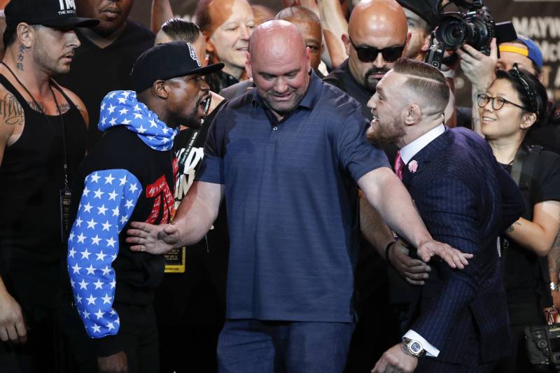 UFC president Dana White, center, intervenes as boxer Floyd Mayweather Jr., left, and mixed martial arts fighter Conor McGregor exchange words during a news conference at Staples Center Tuesday, July 11, 2017, in Los Angeles. The two are scheduled to fight in a boxing match in Las Vegas on Aug. 26. (AP Photo/Jae C. Hong)