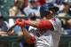 Boston Red Sox's Rafael Devers follows through after hitting a solo home run, his first major-league hit, in the third inning of a baseball game against the Seattle Mariners, Wednesday, July 26, 2017, in Seattle. (AP Photo/Ted S. Warren)