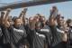 Members of law enforcement raise their fists during a rally to show support for Colin Kaepernick, Saturday, Aug. 19, 2017, in New York. Kaepernick, the former quarterback for the San Francisco 49ers, became a controversial figure last year after he refused to stand for the national anthem. He said it was a protest against oppression of black people. (AP Photo/Mary Altaffer)