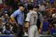 Home plate umpire Angel Hernandez, listens to Detroit Tigers' Ian Kinsler (3) as manager Brad Ausmus stands by in the fifth inning of a baseball game, Monday, Aug. 14, 2017, in Arlington, Texas. Kinsler and Ausmus were ejected by Hernandez during the argument. (AP Photo/Tony Gutierrez)