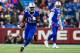 ORCHARD PARK, NY - DECEMBER 24: LeSean McCoy #25 of the Buffalo Bills runs with the ball as teammate Tyrod Taylor #5 looks on against the Miami Dolphins during the first quarter at New Era Field on December 24, 2016 in Orchard Park, New York. The Miami Dolphins defeated the Buffalo Bills 34-31 in overtime. (Photo by Rich Barnes/Getty Images)