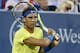 Rafael Nadal, of Spain, returns to Nick Kyrgios, of Australia, at the Western & Southern Open tennis tournament, Friday, Aug. 18, 2017, in Mason, Ohio. (AP Photo/John Minchillo)