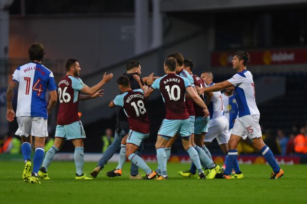 BLACKBURN, ENGLAND - AUGUST 23: Ashley Westwood of Burnley takes a Blackburn fan down during the Carabao Cup Second Round match between Blackburn Rovers and Burnley at Ewood Park on August 23, 2017 in Blackburn, England. (Photo by Nathan Stirk/Getty Images)