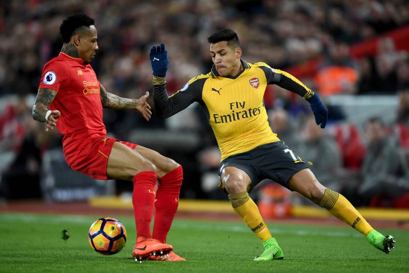 LIVERPOOL, ENGLAND - MARCH 04: Alexis Sanchez of Arsenal (R) attempts to take it past Nathaniel Clyne of Liverpool (L) during the Premier League match between Liverpool and Arsenal at Anfield on March 4, 2017 in Liverpool, England. (Photo by Laurence Griffiths/Getty Images)