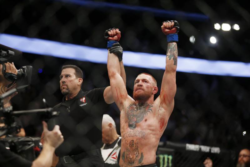 Conor McGregor fights Nate Diaz during their welterweight mixed martial arts bout at UFC 202 on Saturday, Aug. 20, 2016, in Las Vegas. McGregor won by split decision. (AP Photo/Isaac Brekken)