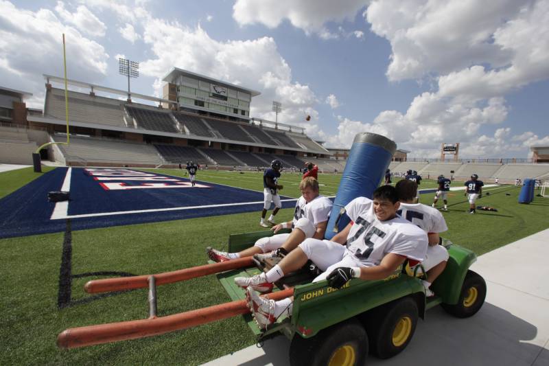 Football players take the field for practice at the new  $60 million new football stadium at Allen High School Tuesday, Aug. 28, 2012 in Allen, Texas.  Allen High School northeast of Dallas christens the stadium Friday night with a matchup against defending state champion Southlake Carroll. While other school districts are struggling to retain teachers and keep classroom sizes down, Allen voters approved a $119 million bond issue that pays for the stadium and other district facilities. (AP Photo/LM Otero)