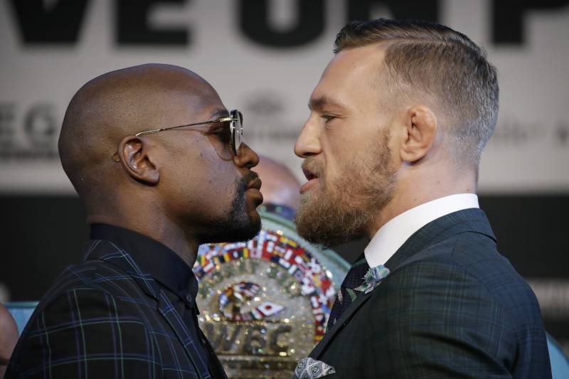 Floyd Mayweather Jr., left, and Conor McGregor pose for photographers during a news conference Wednesday, Aug. 23, 2017, in Las Vegas. The two are scheduled to fight in a boxing match Saturday in Las Vegas. (AP Photo/John Locher)