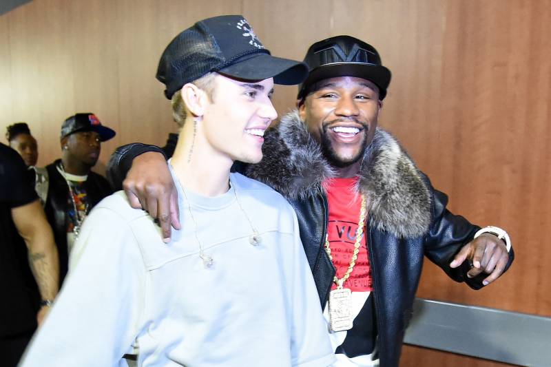 LOS ANGELES, CA - NOVEMBER 13: Singer/songwriter Justin Bieber (L) and professional boxer Floyd Mayweather Jr. walk backstage during An Evening With Justin Bieber at Staples Center on November 13, 2015 in Los Angeles, California. (Photo by Jason Merritt/Getty Images for Universal Music)