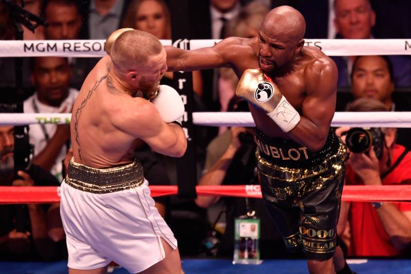 Image result for Mayweather beats McGregor in 10th round T.K.O.