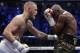 Conor McGregor hits Floyd Mayweather Jr. in a super welterweight boxing match Saturday, Aug. 26, 2017, in Las Vegas. (AP Photo/Isaac Brekken)