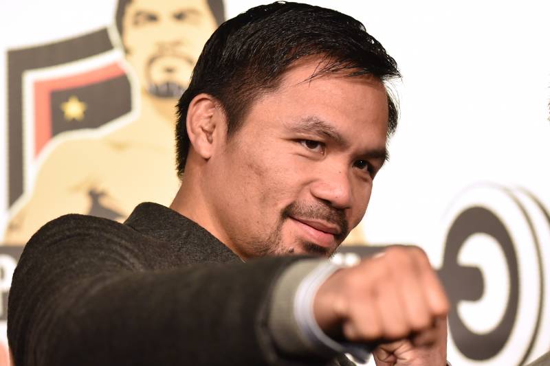 WBO welterweight world champion Manny Pacquiao poses for the media following a press conference at his boxing gym in Tokyo on November 25, 2016. WBO welterweight world champion Manny Pacquiao on November 25 kept alive hopes for a rematch with Floyd Mayweather, saying the epic clash was 'possible' but only if his arch rival returns to the ring. / AFP / KAZUHIRO NOGI (Photo credit should read KAZUHIRO NOGI/AFP/Getty Images)