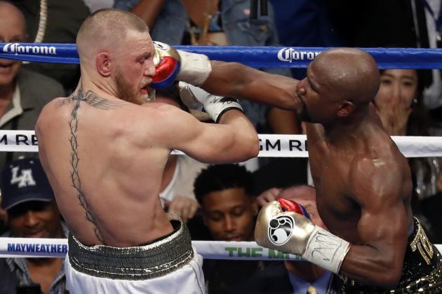 Floyd Mayweather Jr. hits Conor McGregor in a super welterweight boxing match Saturday, Aug. 26, 2017, in Las Vegas. (AP Photo/Eric Jamison)