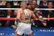 LAS VEGAS, NV - AUGUST 26: (R-L) Floyd Mayweather Jr. holds Conor McGregor during their super welterweight boxing match on August 26, 2017 at T-Mobile Arena in Las Vegas, Nevada. (Photo by Ethan Miller/Getty Images)