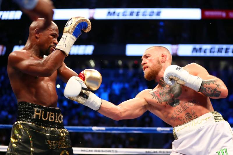 Aug 26, 2017; Las Vegas, NV, USA; Conor McGregor moves in with a hit against Floyd Mayweather Jr. during the sixth round at T-Mobile Arena. Mandatory Credit: Mark J. Rebilas-USA TODAY Sports