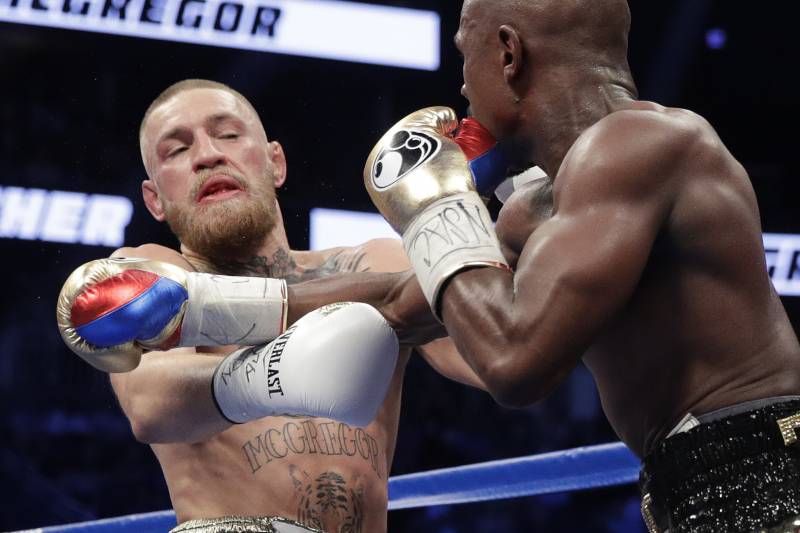 Floyd Mayweather Jr., right, fights Conor McGregor in a super welterweight boxing match Saturday, Aug. 26, 2017, in Las Vegas. (AP Photo/Isaac Brekken)