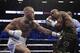 Conor McGregor, left, fights Floyd Mayweather Jr. in a super welterweight boxing match Saturday, Aug. 26, 2017, in Las Vegas. (AP Photo/Isaac Brekken)