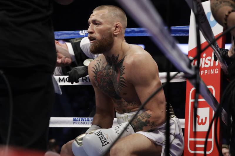 Conor McGregor sits in his corner between rounds in a super welterweight boxing match against Floyd Mayweather Jr., Saturday, Aug. 26, 2017, in Las Vegas. (AP Photo/Isaac Brekken)