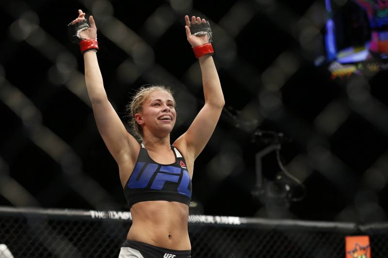 Paige VanZant celebrates after defeating Alex Chambers in their women%26#x2019;s straw weight mixed martial arts bout at UFC 191 on Saturday, Sept. 5, 2015, in Las Vegas. (AP Photo/John Locher)