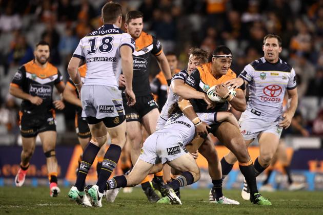 SYDNEY, AUSTRALIA - AUGUST 25: Ava Seumanufagai of the Tigers is tackled during the round 25 NRL match between the Wests Tigers and the North Queensland Cowboys at Campbelltown Sports Stadium on August 25, 2017 in Sydney, Australia. (Photo by Mark Kolbe/Getty Images)