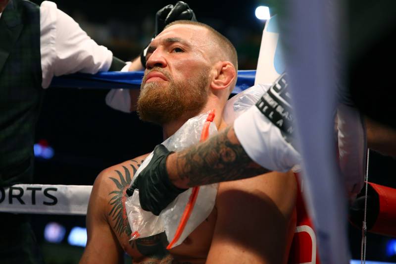 Aug 26, 2017; Las Vegas, NV, USA; Trainers tend to Conor McGregor in his corner between rounds against Floyd Mayweather Jr. (not pictured) during a boxing match at T-Mobile Arena. Mandatory Credit: Mark J. Rebilas-USA TODAY Sports