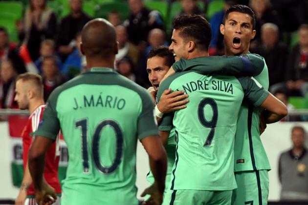 Portugal's André Silva (C) celebrates scoring with teammates including captain Cristiano Ronaldo (R) and João Mário (L) during the FIFA World Cup 2018 qualification football match between Hungary and Portugal at The Grupama Arena in Budapest on September 3, 2017.   / AFP PHOTO / ATTILA KISBENEDEK        (Photo credit should read ATTILA KISBENEDEK/AFP/Getty Images)