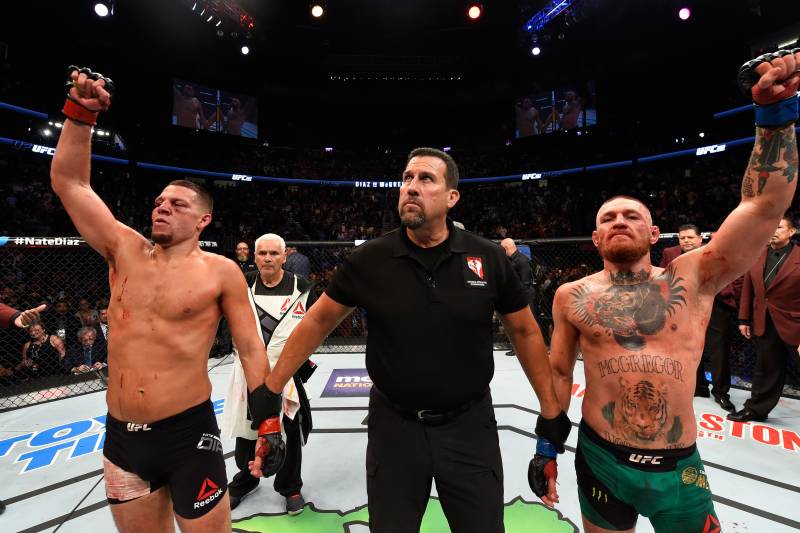 LAS VEGAS, NV - AUGUST 20: (R-L) Conor McGregor of Ireland and Nate Diaz raise their hands and wait to hear the judges decision after their welterweight bout during the UFC 202 event at T-Mobile Arena on August 20, 2016 in Las Vegas, Nevada. (Photo by Josh Hedges/Zuffa LLC/Zuffa LLC via Getty Images)