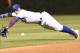 CHICAGO, IL - AUGUST 28: Javier Baez #9 of the Chicago Cubs makes a diving play on a ball off the bat of Jose Osuna of the Pittsburgh Pirates during the third inning on August 28, 2017 at Wrigley Field in Chicago, Illinois. (Photo by David Banks/Getty Images)