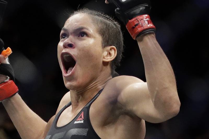 Amanda Nunes celebrates after defeating Ronda Rousey during a women's bantamweight championship mixed martial arts bout at UFC 207, Friday, Dec. 30, 2016, in Las Vegas. (AP Photo/John Locher)