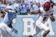 Louisville quarterback Lamar Jackson (8) runs the ball as North Carolina's Tomon Fox (12) chases during the first half of an NCAA college football game in Chapel Hill, N.C., Saturday, Sept. 9, 2017. (AP Photo/Gerry Broome)