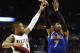 New York Knicks forward Carmelo Anthony (7) shoots over Portland Trail Blazers guard Damian Lillard (0) during the first half of an NBA basketball game in Portland, Ore., Saturday, Dec. 12, 2015. (AP Photo/Steve Dykes)