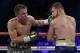 Gennady Golovkin, left, connects with a left to Canelo Alvarez during a middleweight title fight Sunday, Sept. 17, 2017, in Las Vegas. (AP Photo/John Locher)