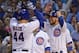 CHICAGO, IL - AUGUST 16: Anthony Rizzo #44 of the Chicago Cubs is greeted by Ben Zobrist #18 (R), Kyle Schwarber #12 and Kris Bryant #17 after hitting a grand slam home run in the 1st inning against the Cincinnati Reds at Wrigley Field on August 16, 2017 in Chicago, Illinois. (Photo by Jonathan Daniel/Getty Images)