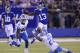 New York Giants wide receiver Odell Beckham (13) leaps over Detroit Lions' Glover Quin (27) as Jarrad Davis (40) watches during the first half of an NFL football game, Monday, Sept. 18, 2017, in East Rutherford, N.J. (AP Photo/Bill Kostroun)