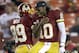 Washington Redskins wide receiver Santana Moss and quarterback Robert Griffin III jump into to each other before an NFL football game against the New York Giants in Landover, Md., Monday, Dec. 3, 2012. (AP Photo/Evan Vucci)
