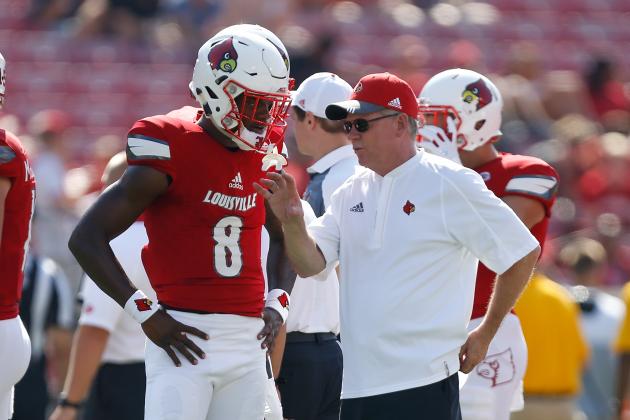 LOUISVILLE, KY - SEPTEMBER 23:  Head coach Bobby Petrino of the Louisville Cardinals talks with Lamar Jackson #8 prior to the game against the Kent State Golden Flashes at Papa John's Cardinal Stadium on September 23, 2017 in Louisville, Kentucky.  (Photo by Michael Reaves/Getty Images)