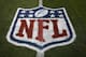 The NFL logo is shown at mid field prior to an NFL preseason football game between the Denver Broncos and the Arizona Cardinals, Thursday, Aug. 31, 2017, in Denver. (AP Photo/Jack Dempsey)