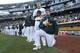 OAKLAND, CA - SEPTEMBER 23: Bruce Maxwell #13 (R) of the Oakland Athletics kneels during the national anthem prior to the game against the Texas Rangers at the Oakland Alameda Coliseum on September 23, 2017 in Oakland, California. The Athletics defeated the Rangers 1-0. (Photo by Michael Zagaris/Oakland Athletics/Getty Images)