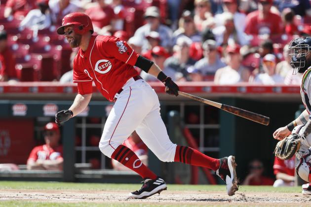 Cincinnati Reds' Zack Cozart hits a single off of Boston Red Sox starting pitcher Doug Fister in the first inning of a baseball game, Sunday, Sept. 24, 2017, in Cincinnati. The Red Sox won 5-4. (AP Photo/John Minchillo)