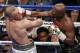 FILE - In this Aug. 26, 2017, file photo, Floyd Mayweather Jr. hits Conor McGregor in a super welterweight boxing match in Las Vegas. The AP reported on Sept. 1, 2017, that a story claiming a boxing promoter connected to the fight was found shot dead in Washington, D.C. is a hoax. (AP Photo/Eric Jamison, File)