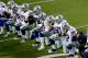 The Dallas Cowboys take a knee prior to the national anthem prior to an NFL football game against the Arizona Cardinals, Monday, Sept. 25, 2017, in Glendale, Ariz. (AP Photo/Matt York)