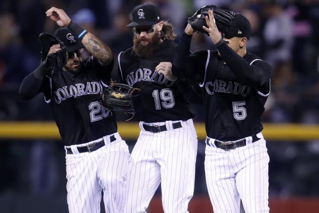 Colorado Rockies left fielder Ian Desmond, center fielder Charlie Blackmon and right fielder Carlos Gonzalez, from left, jump after the Rockies defeated theLos Angeles Dodgers 9-1 in a baseball game Friday, Sept. 29, 2017, in Denver. (AP Photo/David Zalubowski)