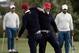 United States' Kevin Chappell, second from left, and Charley Hoffman lock arms in celebration after Hoffman sunk his putt on the 13th hole during the four-ball golf matches on the third day of the Presidents Cup at Liberty National Golf Club in Jersey City, N.J., Saturday, Sept. 30, 2017. Watching in the background are Anirban Lahiri, right, of India, and his International teammate Si Woo Kim, of South Korea. (AP Photo/Julio Cortez)
