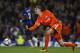 Chelsea's Belgian goalkeeper Thibaut Courtois rolls the ball out during the English Premier League football match between Chelsea and Manchester City at Stamford Bridge in London on September 30, 2017. / AFP PHOTO / Adrian DENNIS / RESTRICTED TO EDITORIAL USE. No use with unauthorized audio, video, data, fixture lists, club/league logos or 'live' services. Online in-match use limited to 75 images, no video emulation. No use in betting, games or single club/league/player publications. / (Photo credit should read ADRIAN DENNIS/AFP/Getty Images)