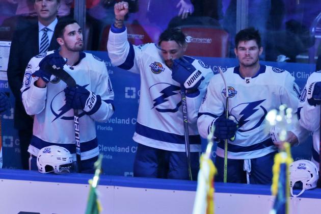 Tampa Bay Lightning right wing J.T. Brown, center, raises his fist in the air during the singing of the national nnthem before the start of an NHL hockey game between the Florida Panthers and the Tampa Bay Lightning, Saturday, Oct. 7, 2017, in Sunrise, Fla. (AP Photo/Wilfredo Lee),