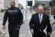 Lamont Evans, left, an assistant basketball coach at Oklahoma State University, and his attorney Trace Morgan leave the federal courthouse following a court appearance in Oklahoma City, Wednesday, Sept. 27, 2017. Evans is facing federal charges in conjunction with a wide probe of fraud and corruption in the NCAA. (AP Photo/Sue Ogrocki)