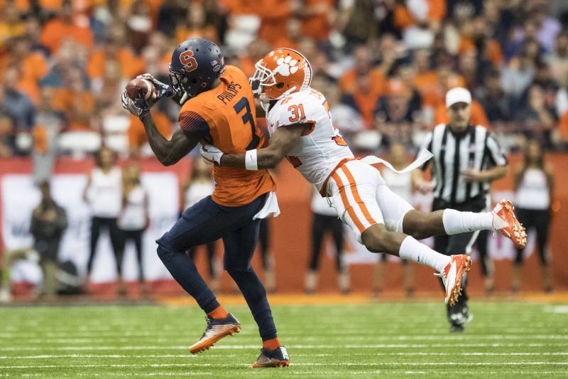 SYRACUSE, NY - OCTOBER 13: Ervin Philips #3 of the Syracuse Orange makes a first down reception during the second quarter as he is tackled by Ryan Carter #31 of the Clemson Tigers at the Carrier Dome on October 13, 2017 in Syracuse, New York. (Photo by Brett Carlsen/Getty Images)