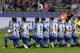 Players of Berlin kneel down prior to the German Bundesliga soccer match between Hertha BSC Berlin and FC Schalke 04 in Berlin, Germany, Saturday, Oct. 14, 2017. Hertha Berlin nodded to social struggles in the United States by kneeling before its Bundesliga game at home to Schalke on Saturday. Hertha’s starting lineup linked arms and took a knee on the pitch, while coaching staff, officials and substitutes took a knee off it. The action was intended to show solidarity with NFL players who have been demonstrating against discrimination in the US by kneeling, sitting or locking arms through the anthem before games. (AP Photo/Michael Sohn)